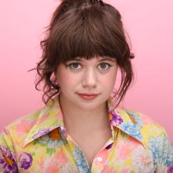 Anna Faye Lieberman Headshot, a white woman with brown hair in a colorful shirt