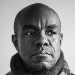 A black and white headshot of actor Dwayne Alistair Thomas.