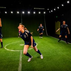 Leanna Doyle ("Sammy) runs across the field in Same Team while others cheer her on.
