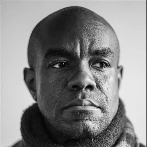 A black and white headshot of actor Dwayne Alistair Thomas.