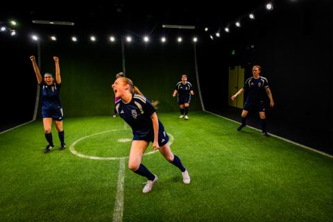 Leanna Doyle ("Sammy) runs across the field in Same Team while others cheer her on.
